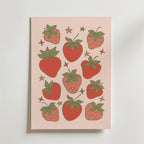 Bozetto Cute Strawberries Poster föreställer nio illustrerade jordgubbar, gröna blad och små gula stjärnor på en ljusrosa bakgrund - perfekt för retroinredning eller köksdekoration.